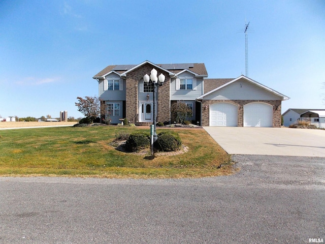 view of front of home with a front lawn and a garage