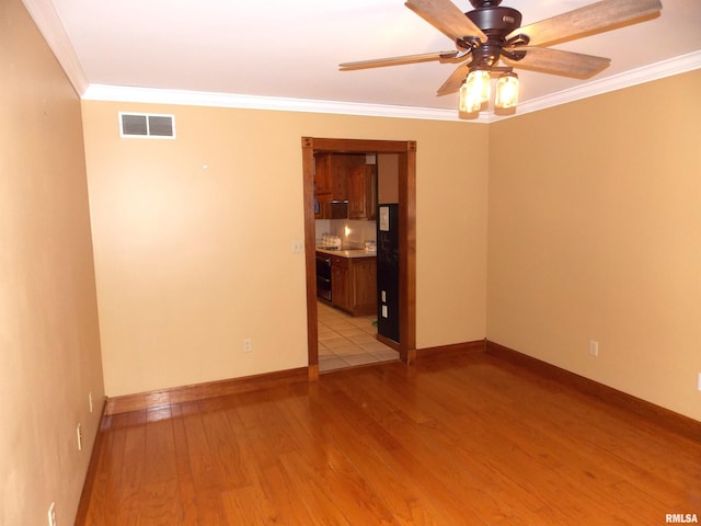 spare room with ornamental molding, light hardwood / wood-style floors, and ceiling fan