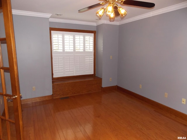 empty room featuring ceiling fan, hardwood / wood-style flooring, and ornamental molding