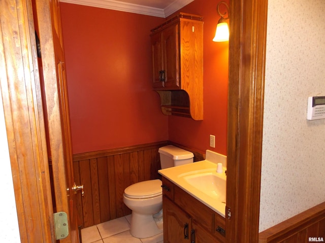 bathroom featuring toilet, wooden walls, vanity, crown molding, and tile patterned flooring