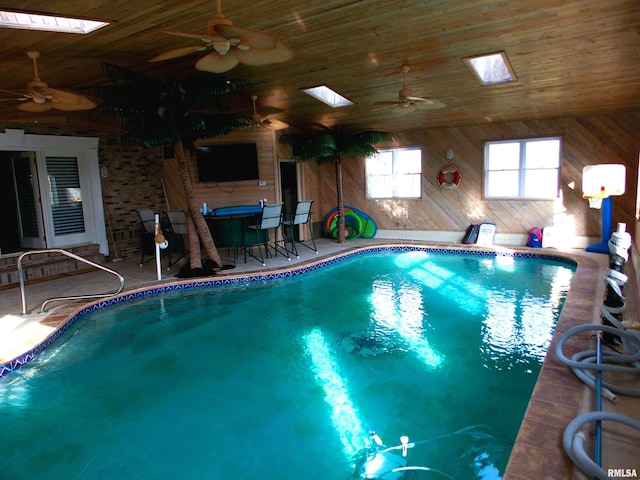 view of swimming pool featuring ceiling fan and a skylight