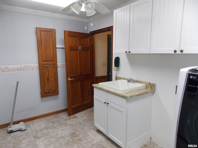 kitchen featuring light stone countertops, sink, ceiling fan, white cabinets, and ornamental molding