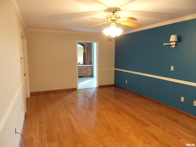 spare room with ceiling fan, ornamental molding, and light hardwood / wood-style flooring