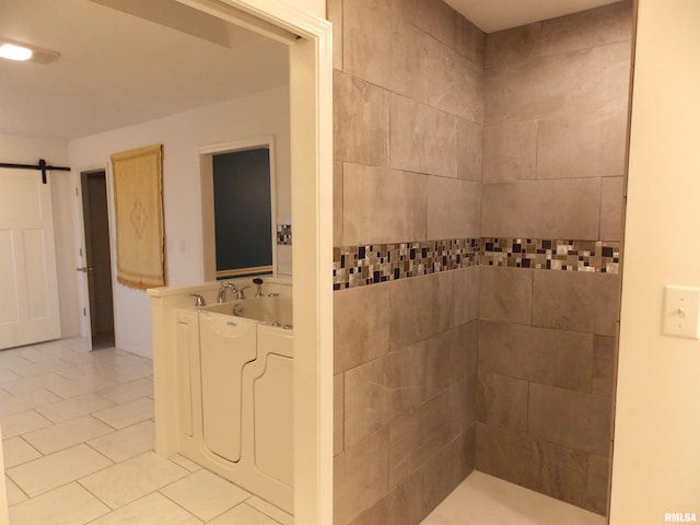 bathroom with a tub to relax in and tile patterned floors