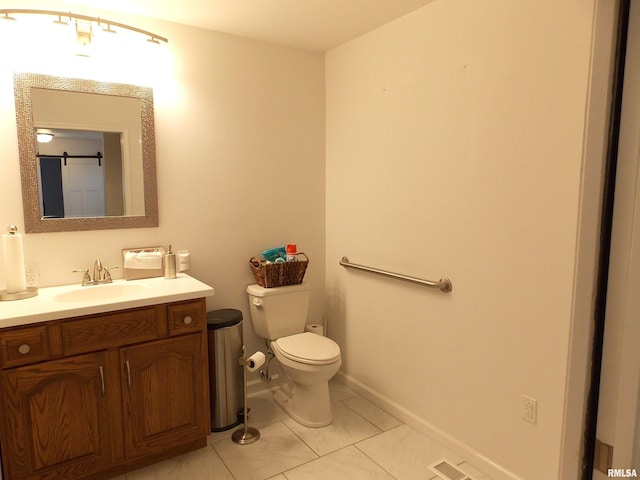 bathroom featuring toilet, vanity, and tile patterned floors