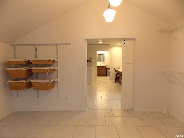 interior space with light tile patterned flooring and high vaulted ceiling