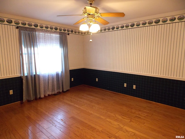 unfurnished room featuring ornamental molding, hardwood / wood-style floors, and ceiling fan