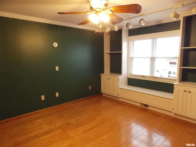 interior space with crown molding, light hardwood / wood-style flooring, and ceiling fan