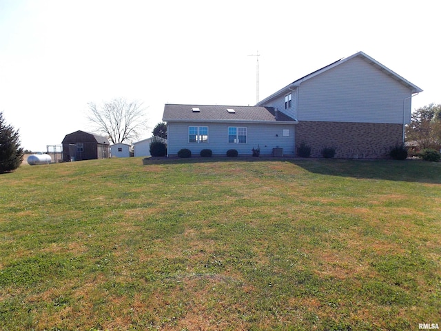 back of property featuring a shed and a lawn