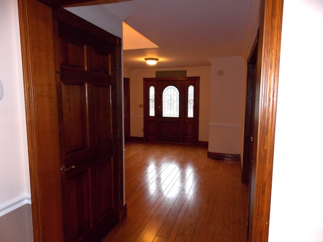 foyer with crown molding and hardwood / wood-style flooring