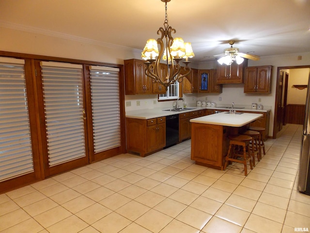 kitchen featuring black dishwasher, a center island, hanging light fixtures, ornamental molding, and a breakfast bar area