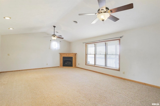 unfurnished living room with vaulted ceiling, carpet flooring, and ceiling fan