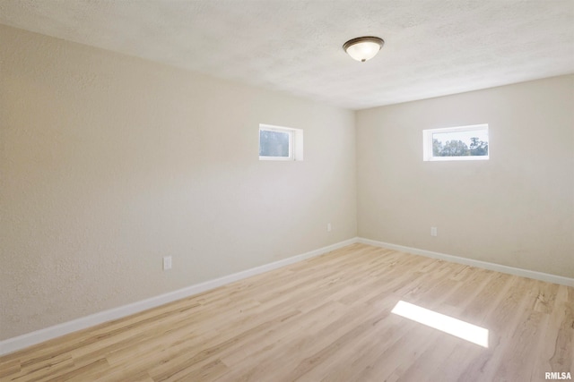 spare room with light hardwood / wood-style flooring