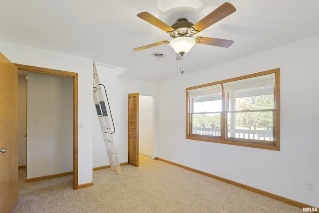 unfurnished bedroom featuring light colored carpet and ceiling fan