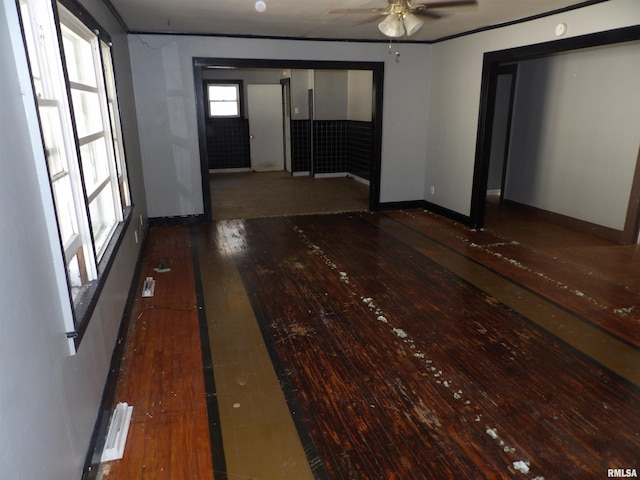 empty room with ceiling fan and dark hardwood / wood-style flooring