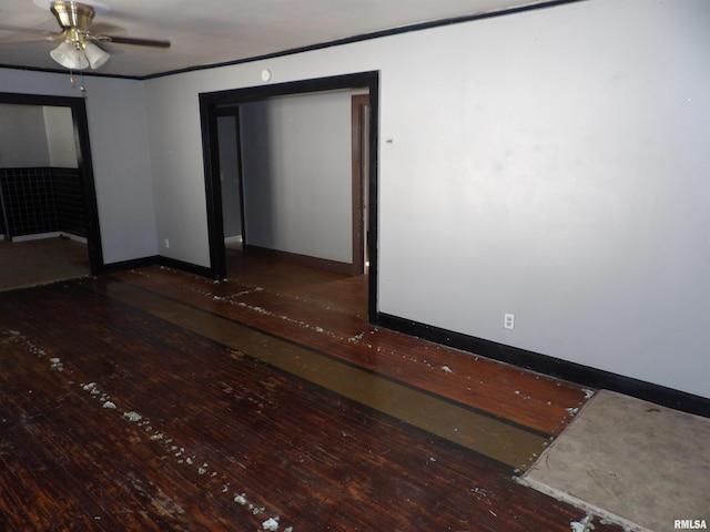 spare room featuring dark wood-type flooring and ceiling fan