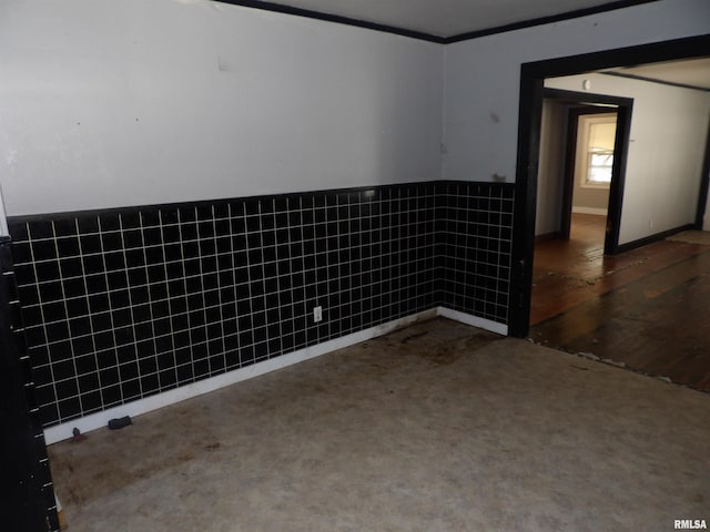 empty room with tile walls and dark hardwood / wood-style flooring