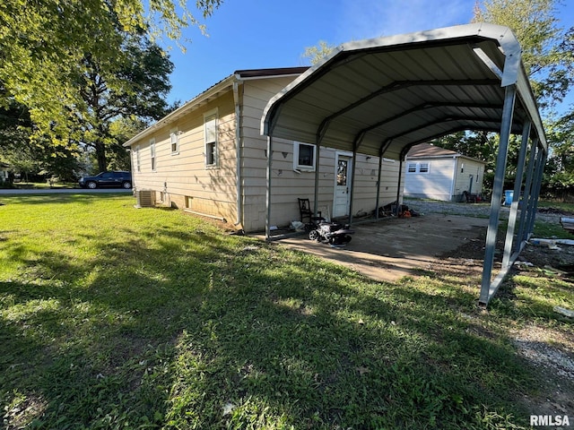 view of parking featuring a yard and a carport