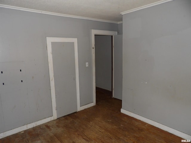 unfurnished room featuring crown molding and dark hardwood / wood-style floors