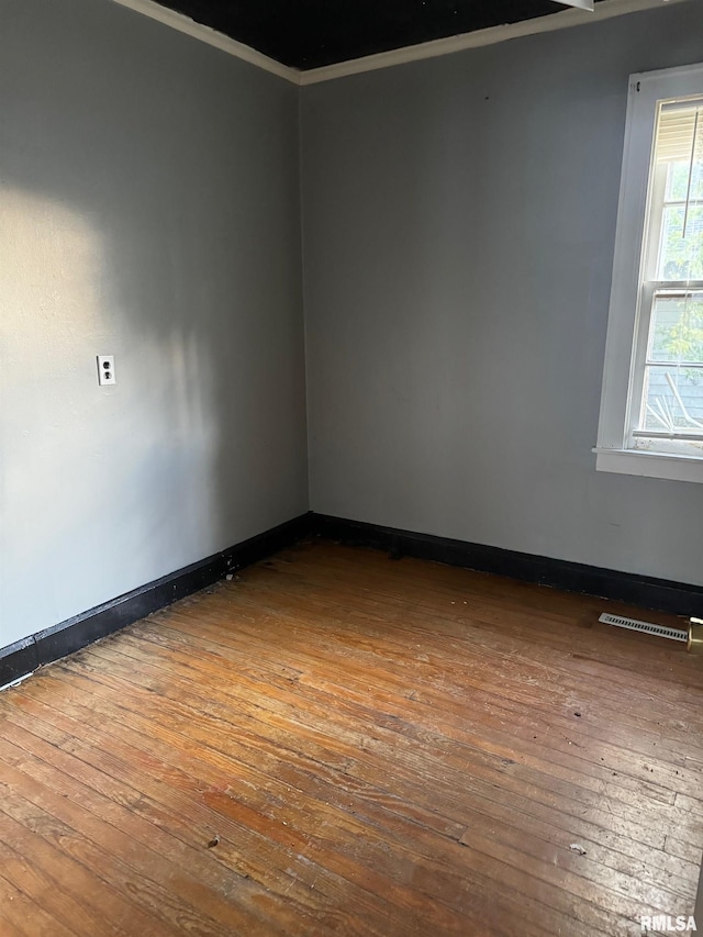 unfurnished room with wood-type flooring