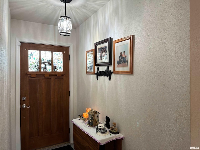 104 Townhouse Dr, Cambria, IL 62915 - entryway with a textured wall and a chandelier