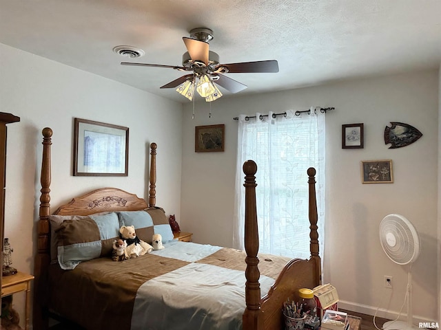 104 Townhouse Dr, Cambria, IL 62915 - bedroom with baseboards, ceiling fan, and visible vents