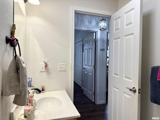 104 Townhouse Dr, Cambria, IL 62915 - bathroom featuring vanity, a textured wall, and wood finished floors