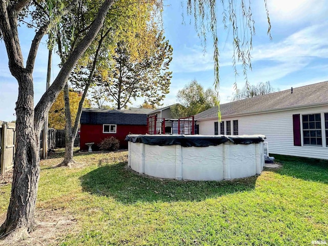 104 Townhouse Dr, Cambria, IL 62915 - back of property featuring a yard, fence, and a covered pool