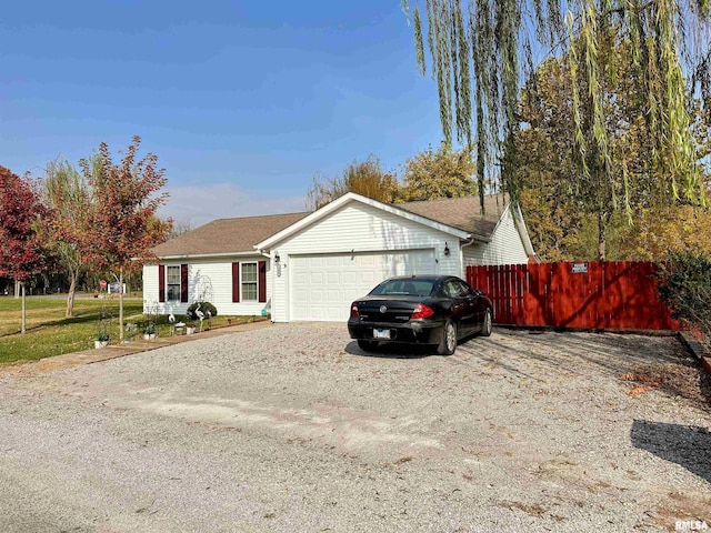 104 Townhouse Dr, Cambria, IL 62915 - single story home with fence, driveway, roof with shingles, and a garage