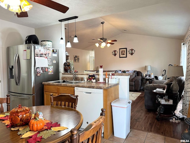 104 Townhouse Dr, Cambria, IL 62915 - kitchen featuring dark countertops, open floor plan, ceiling fan, stainless steel fridge, and dishwasher