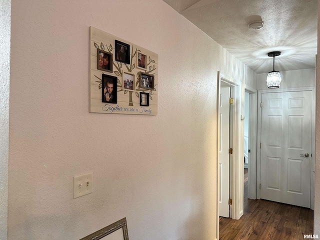104 Townhouse Dr, Cambria, IL 62915 - hallway featuring a textured wall, a notable chandelier, and dark wood finished floors