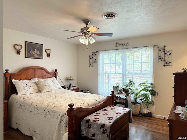 104 Townhouse Dr, Cambria, IL 62915 - bedroom featuring ceiling fan, baseboards, visible vents, and wood finished floors