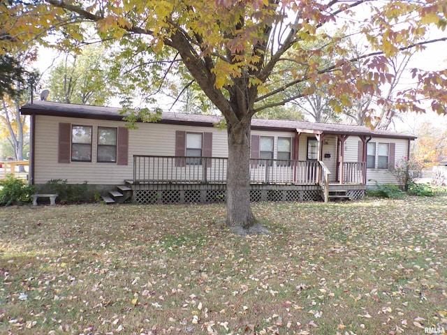 ranch-style home featuring a front yard and a deck