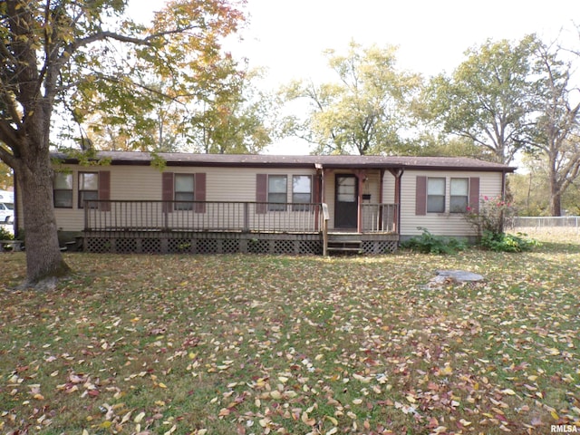 view of front of property with a wooden deck and a front lawn