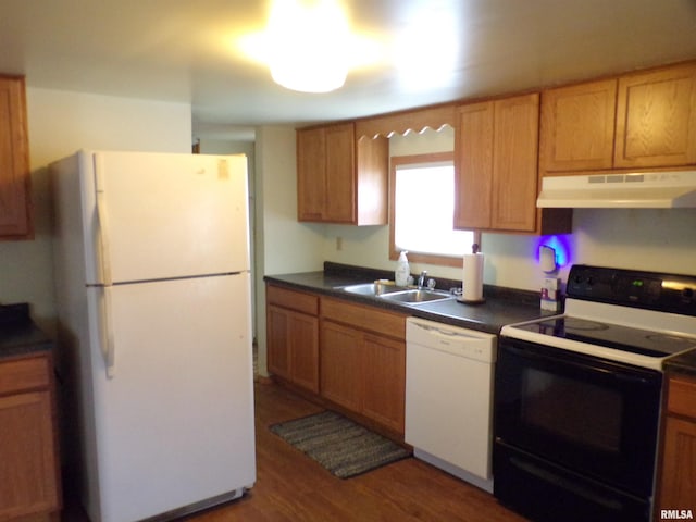 kitchen with sink, dark wood-type flooring, and white appliances