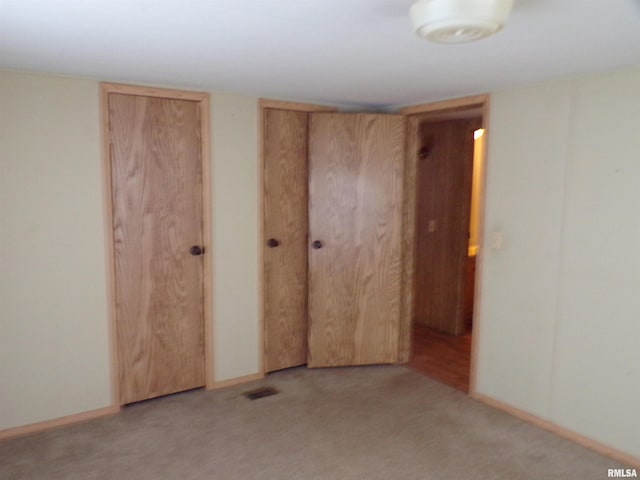 unfurnished bedroom with light colored carpet