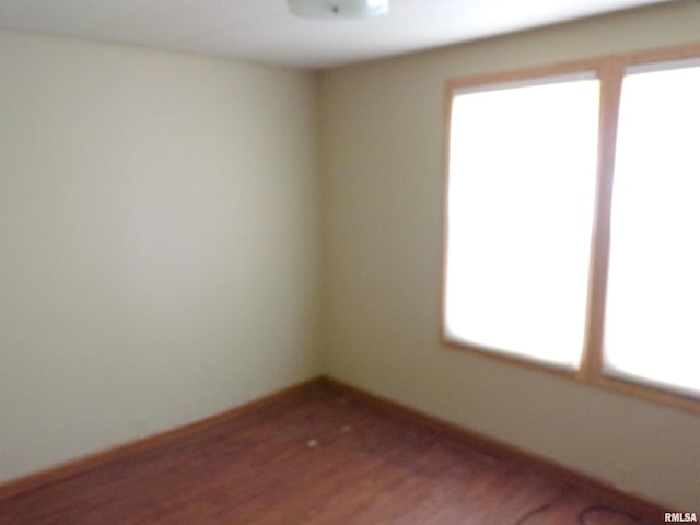 unfurnished room featuring wood-type flooring