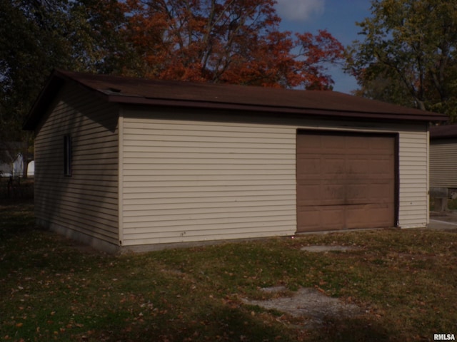 view of garage at dusk