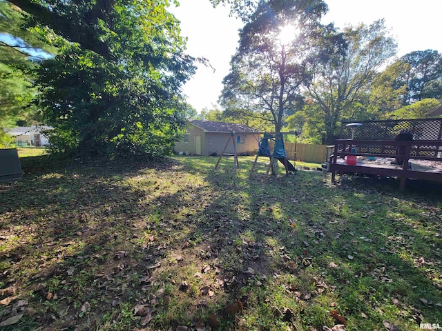 view of yard with a deck and a playground