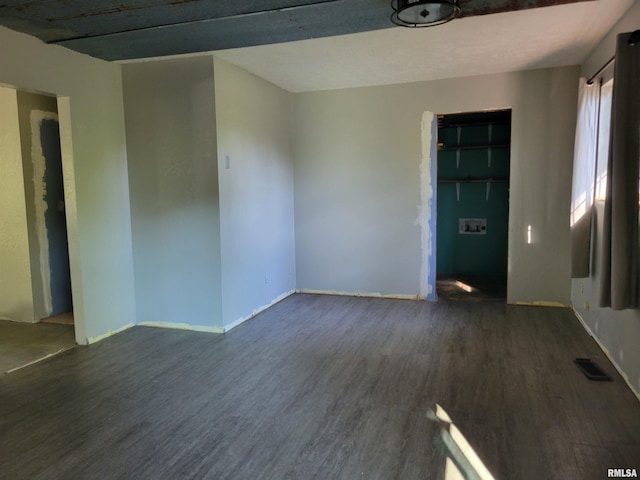 spare room with dark wood-type flooring