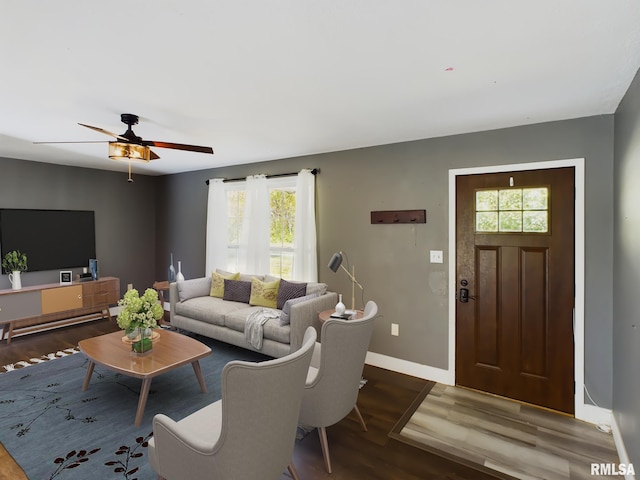 living room featuring ceiling fan and dark hardwood / wood-style flooring