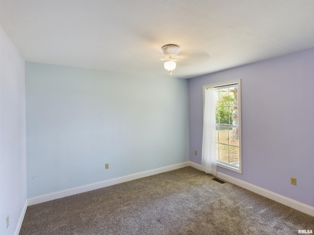 unfurnished room with ceiling fan and carpet floors