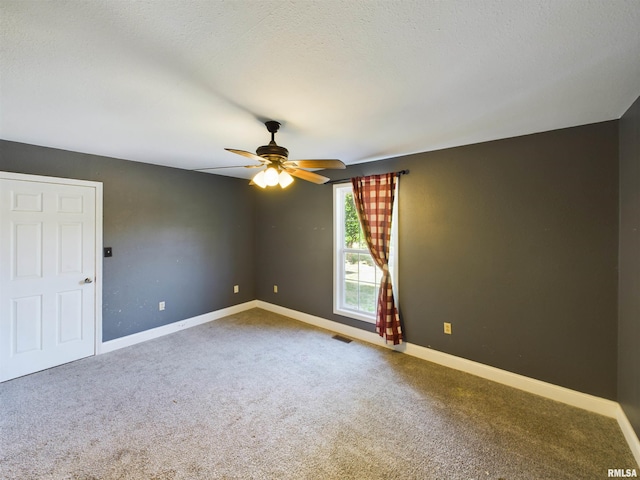 carpeted empty room featuring a textured ceiling and ceiling fan