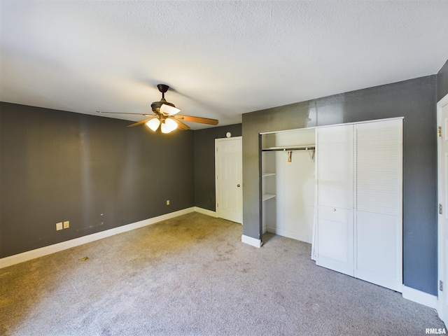 unfurnished bedroom featuring ceiling fan, a textured ceiling, and light colored carpet