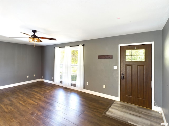 foyer entrance featuring dark wood-type flooring and ceiling fan