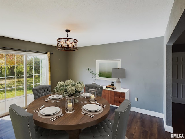 dining area with a chandelier and dark wood-type flooring