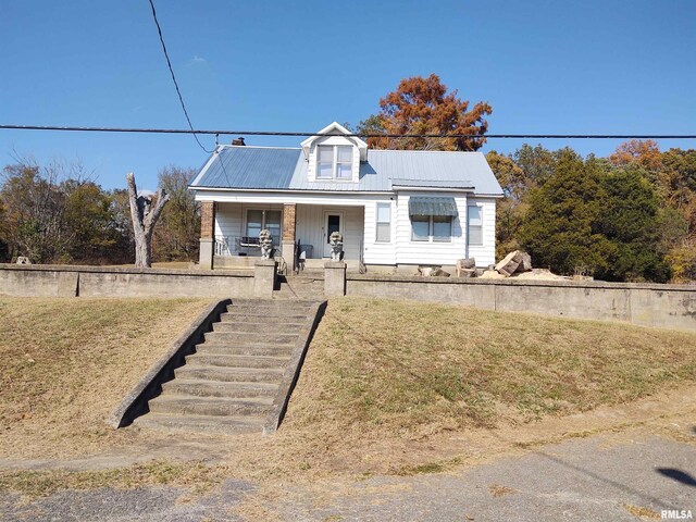 7280 Buncombe Rd, Buncombe, IL 62912 - bungalow with metal roof, a porch, and a front lawn