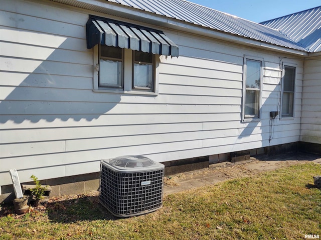 7280 Buncombe Rd, Buncombe, IL 62912 - view of property exterior featuring a yard, cooling unit, and metal roof