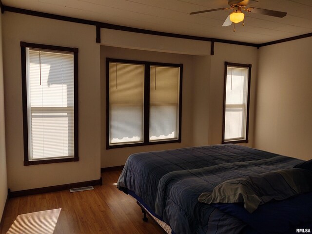 7280 Buncombe Rd, Buncombe, IL 62912 - bedroom featuring baseboards, visible vents, ornamental molding, and wood finished floors