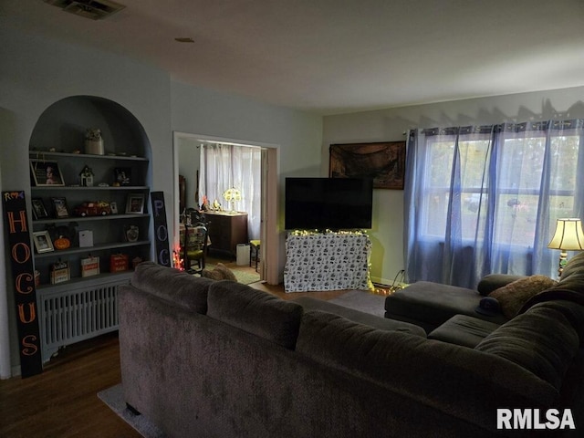 living room featuring hardwood / wood-style flooring and radiator heating unit